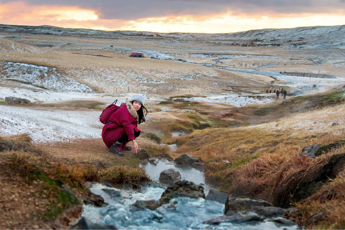 Female traveler by a river in Iceland