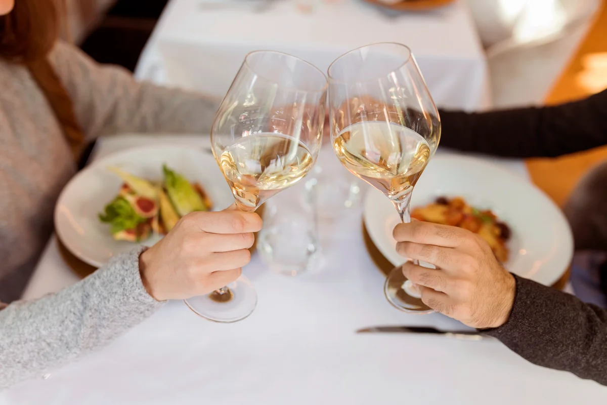 Couple clinking wine glasses in a restaurant