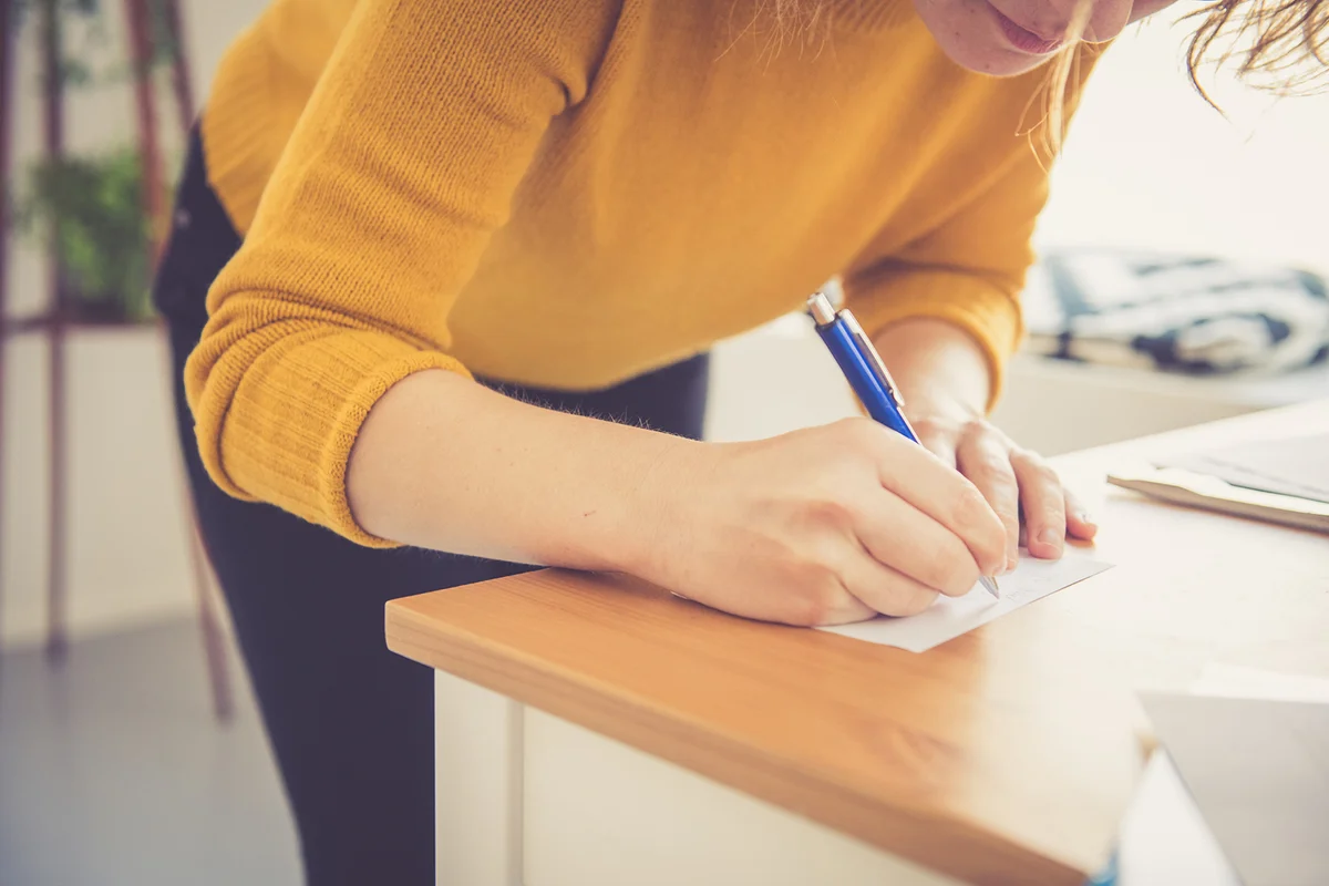 Female hands Close Up writing notes with a pen