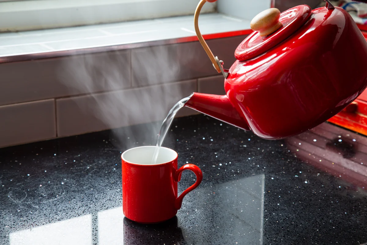 pouring hot water into a mug
