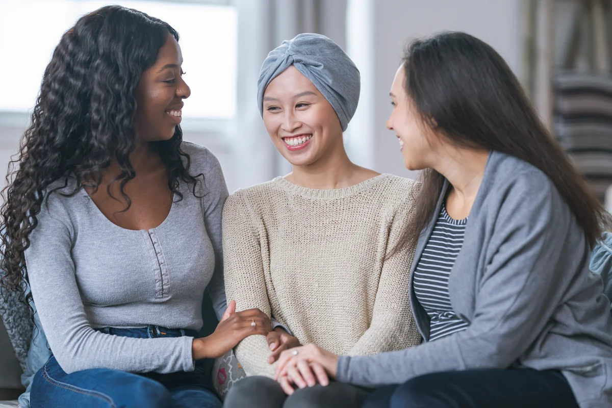 friends sitting with a woman with cancer