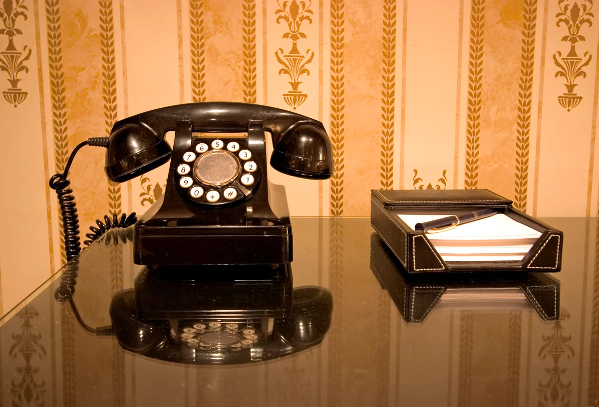 Black vintage telephone on table