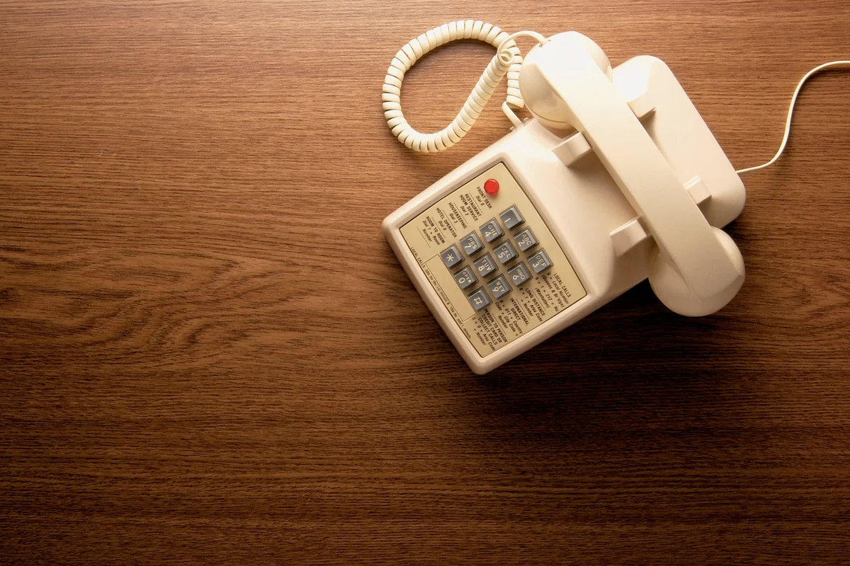 white office phone  on table