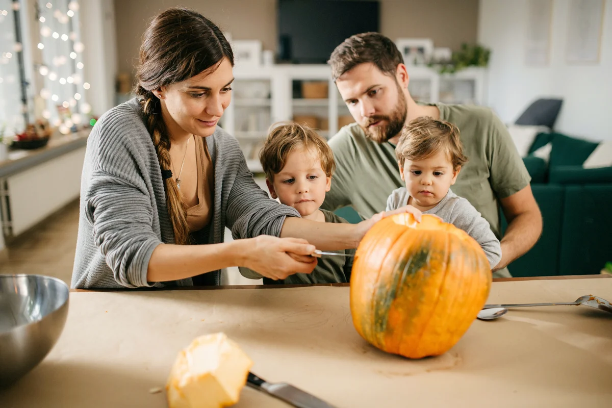 Family scooping a pumpkin for Haloween