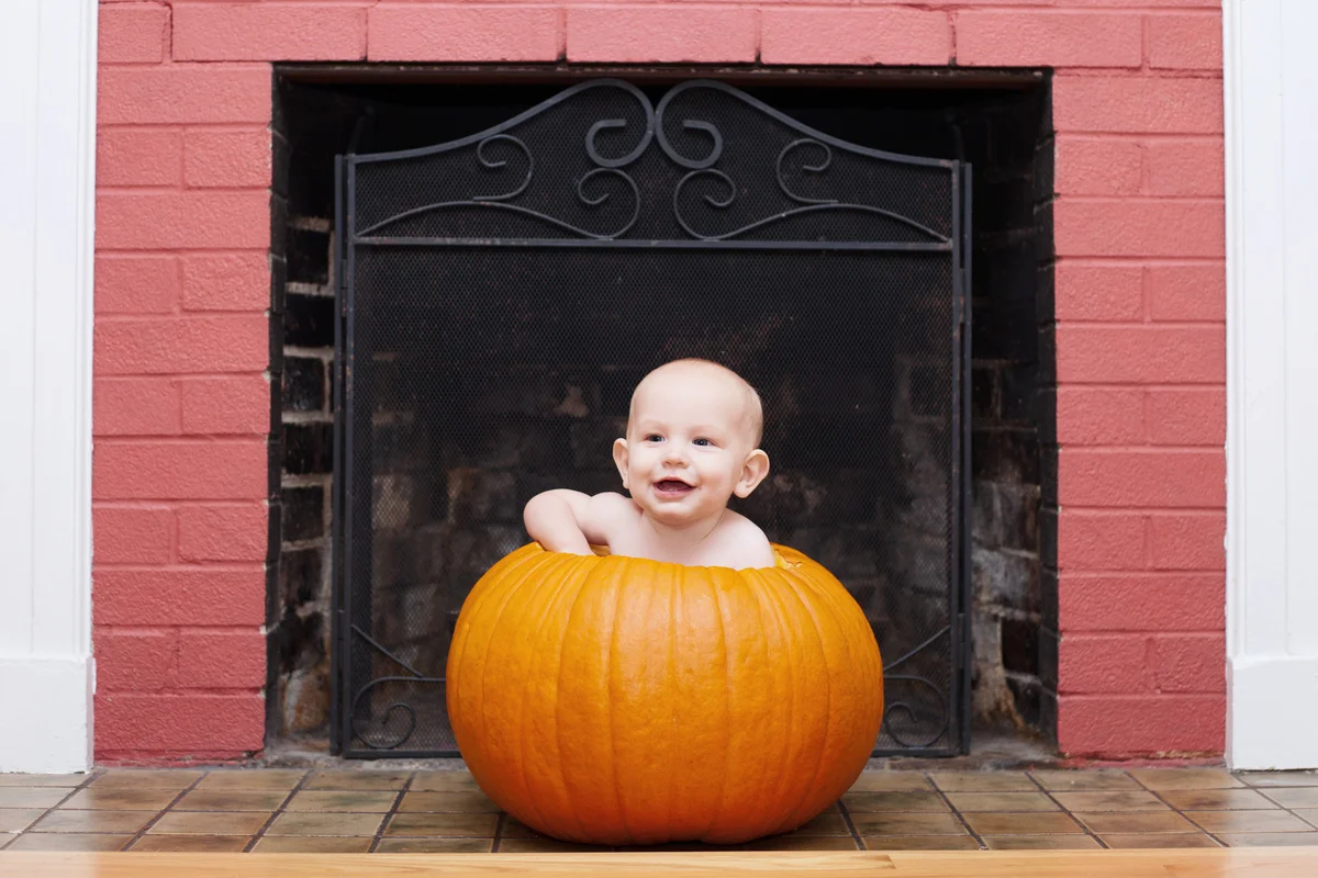 Naked baby in hollowed out pumpkin