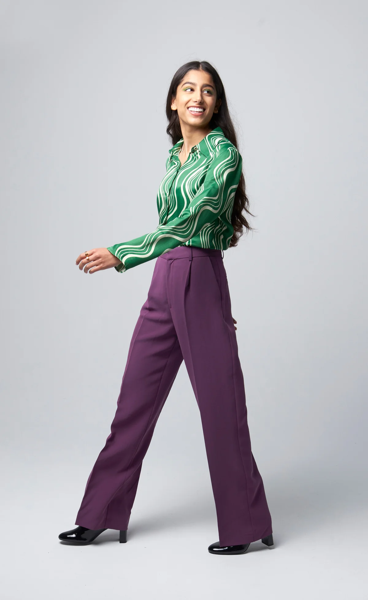 woman in purple pants and stylish green shirt
