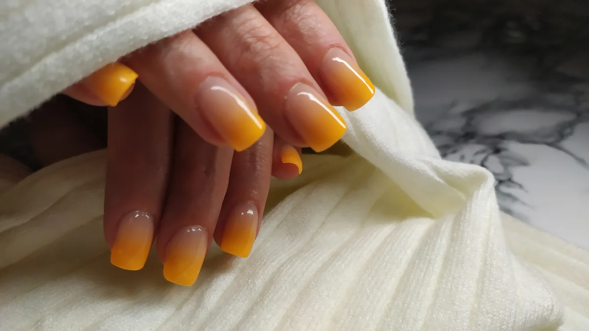 closeup of yellow ombre manicure