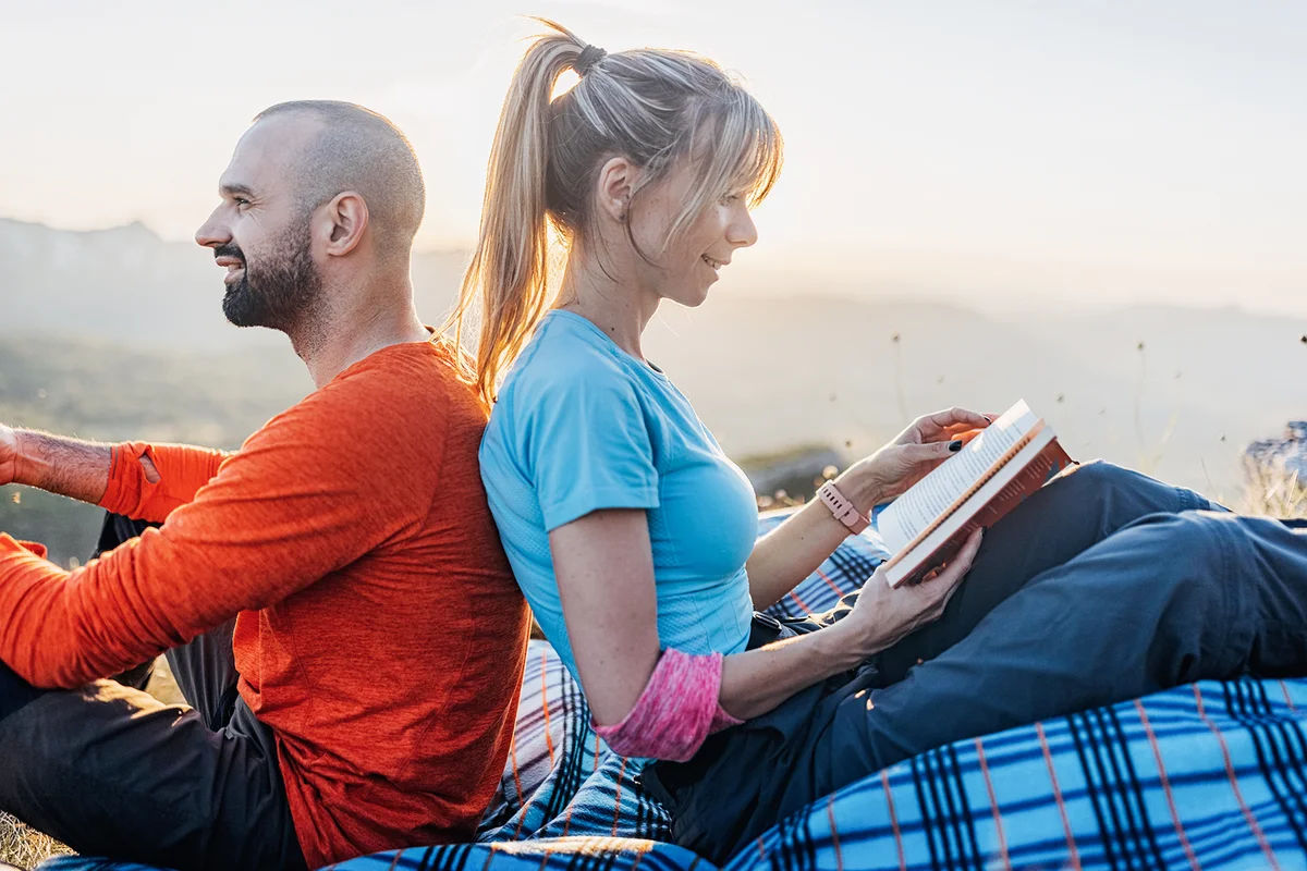 A young couple is relaxing on the mountain