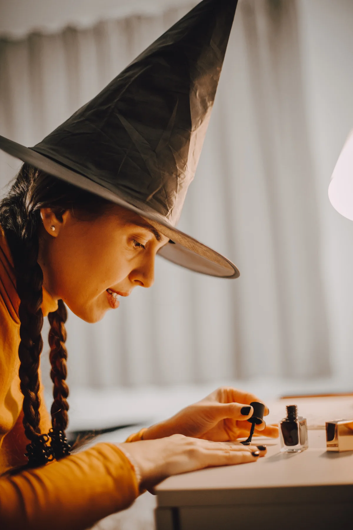 A woman paints her nails for Halloween