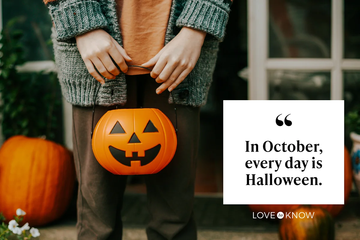 Boy holding a halloween cup full of candies