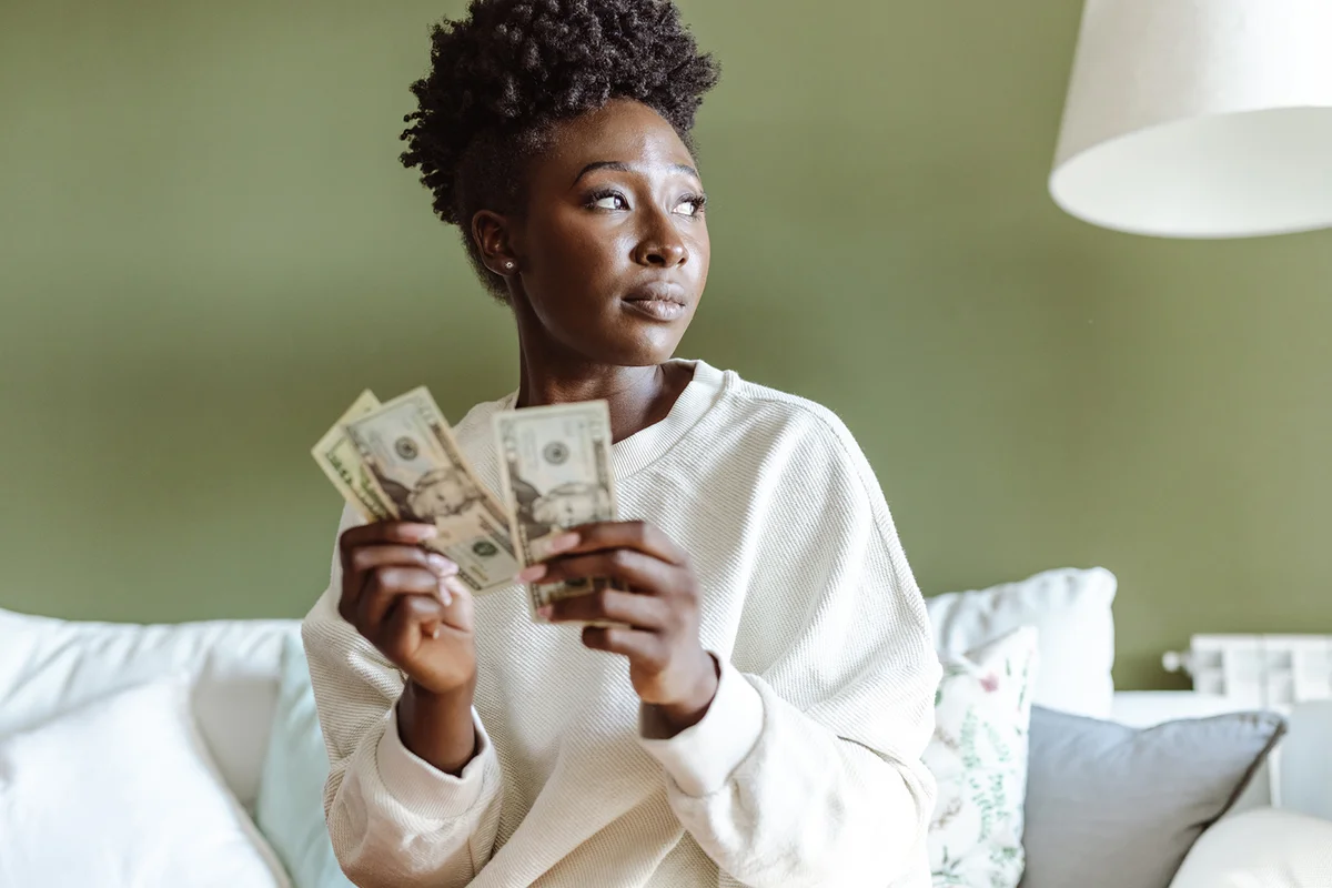 woman counts money at home