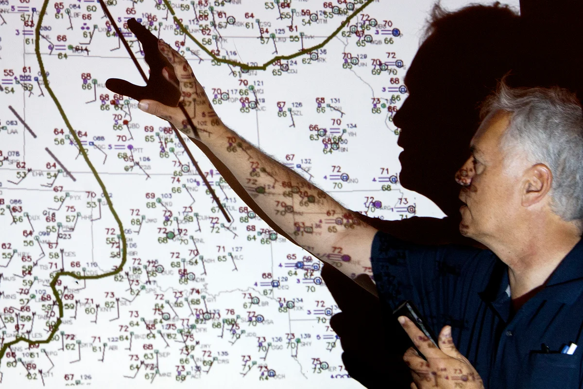 Scientist and forecaster Tim Marshall explains a weather map