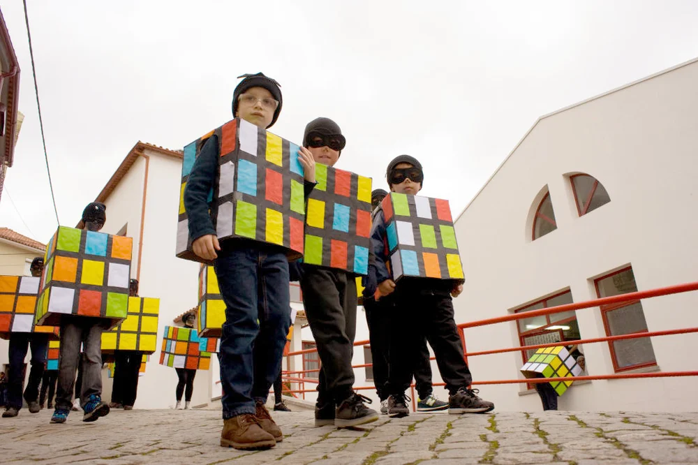 Kids dressed up as Rubik's cubes