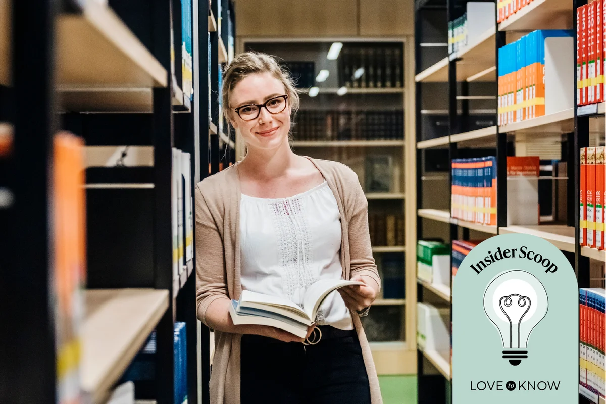 Librarian Leaning On Bookshelf