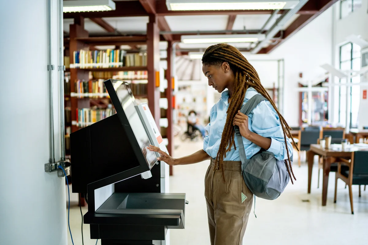 Student searching for a book in the library system