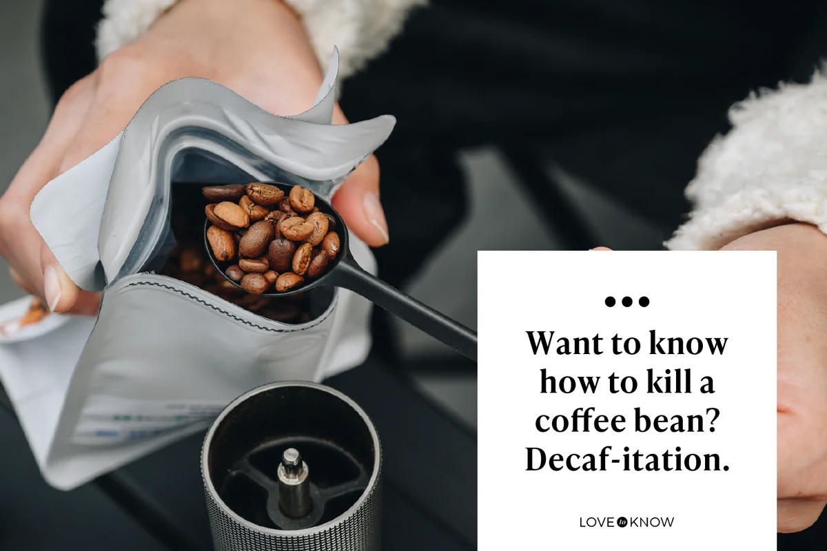 Cropped shot of barista while adding coffee beans into manual coffee grinder