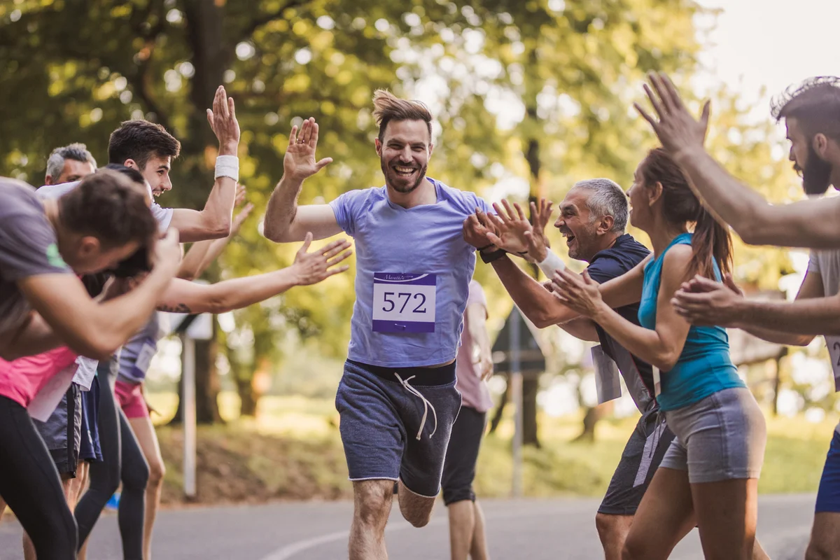Man running surrounded by people
