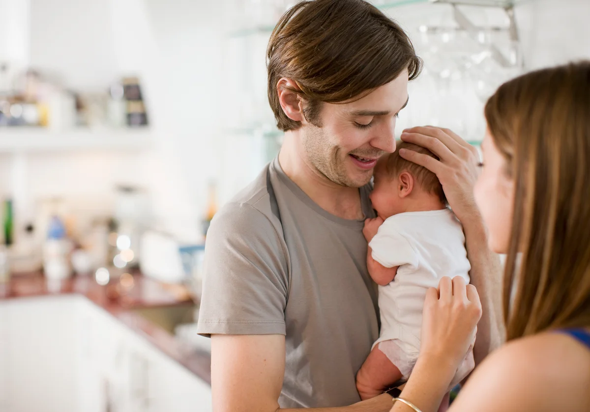 Father holding newborn baby