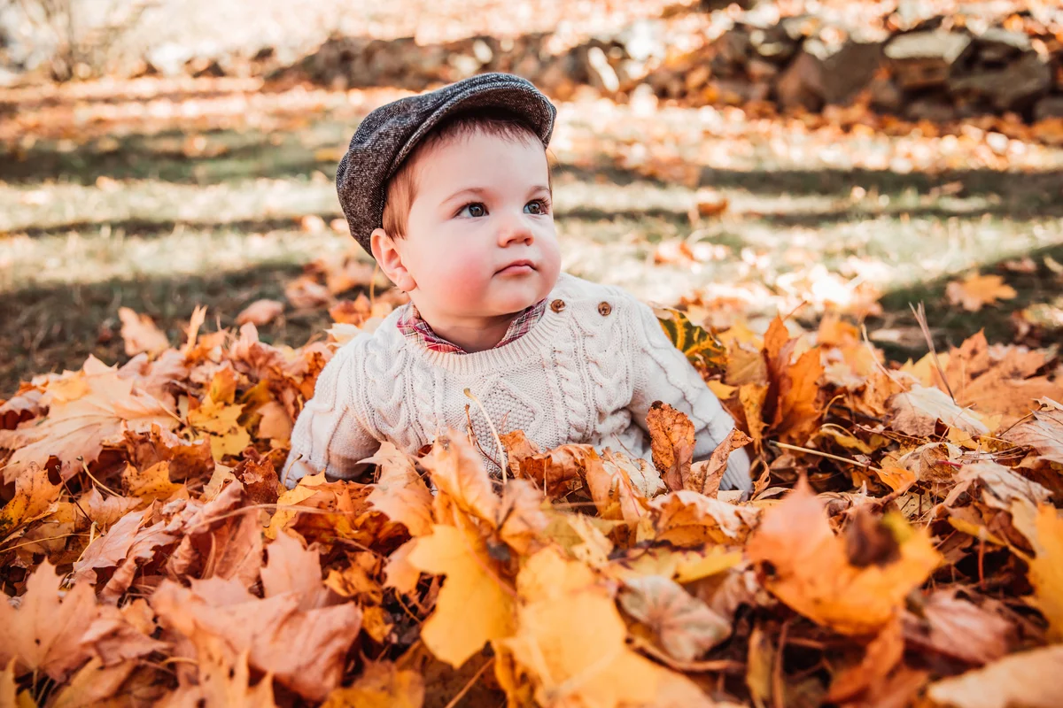 baby boy in leaves