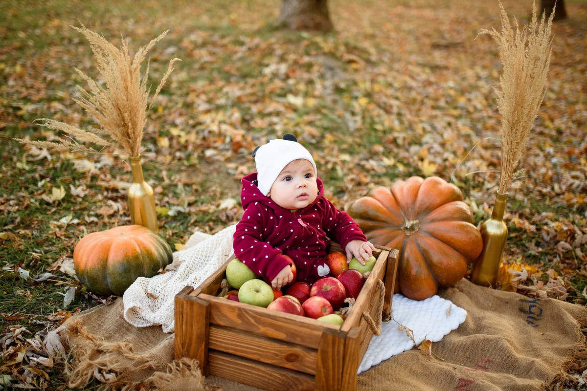 baby girl in apples