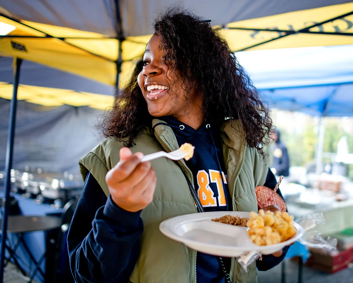 woman eating tailgate food