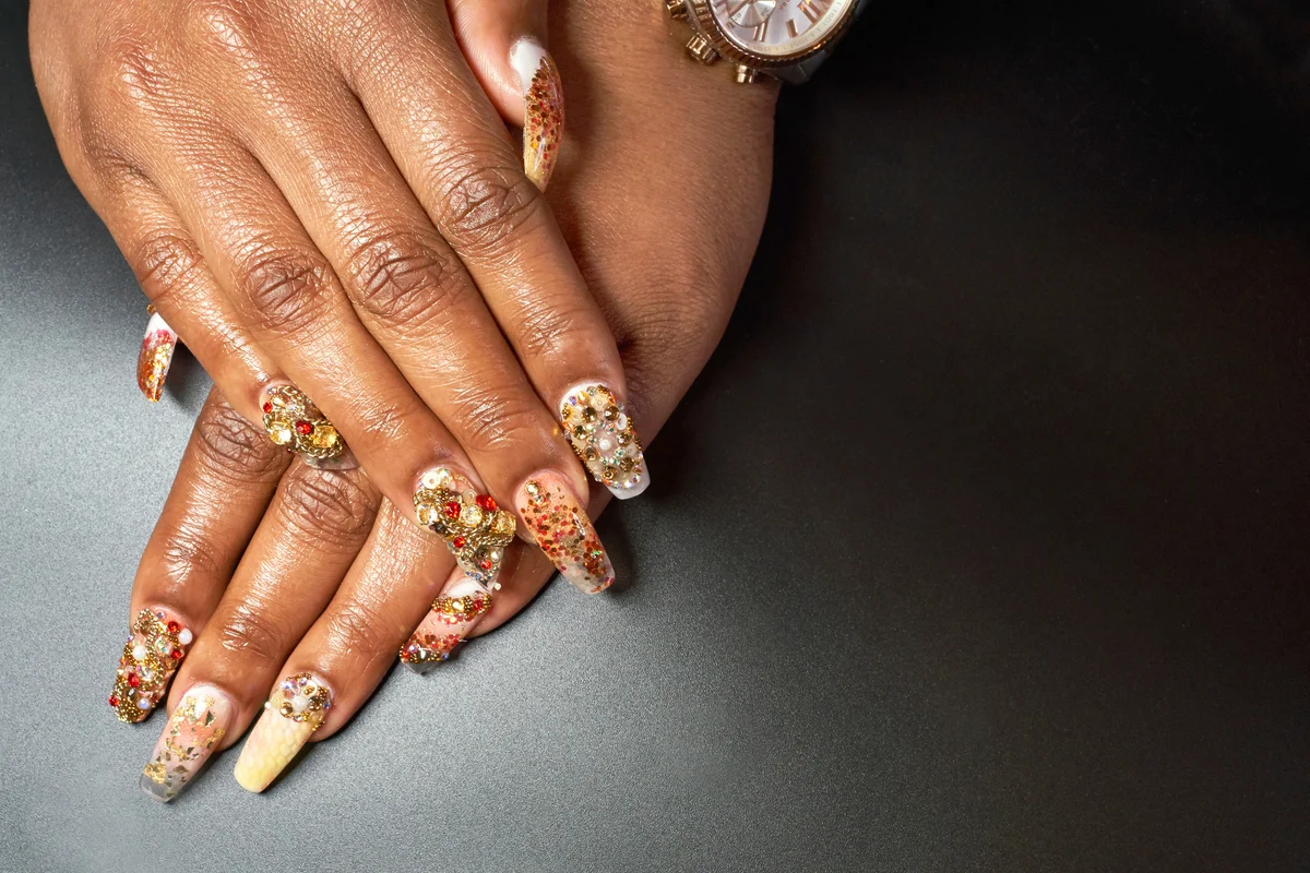 Manicured hand and chandelier nails