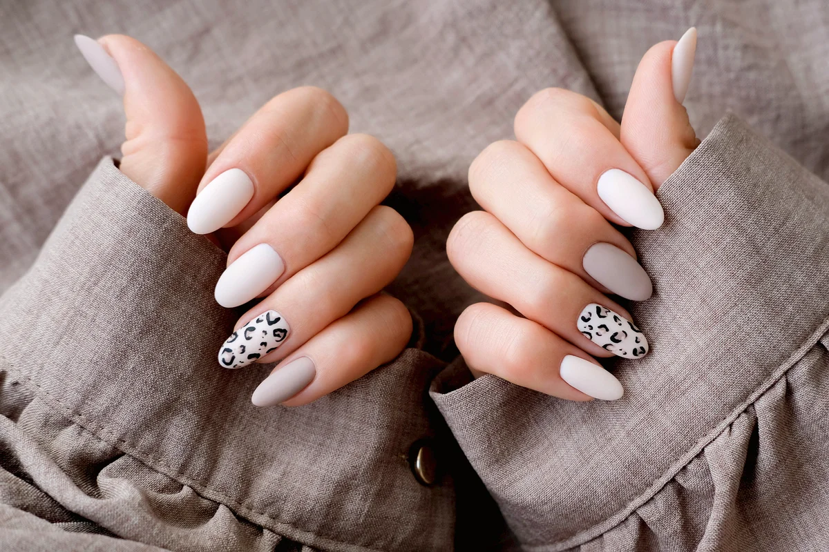Autumn trend, beige color polishing with leopard pattern on nails