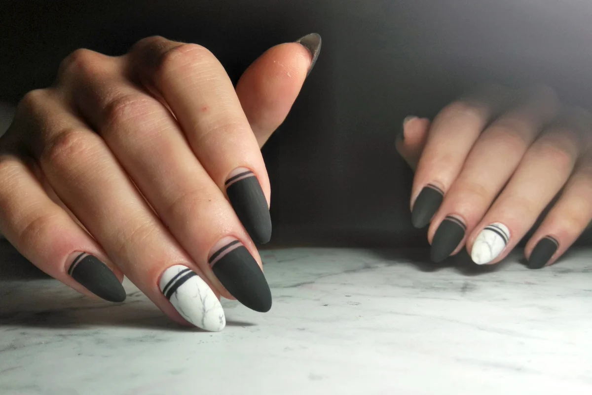 Matte black gel polish with geometric designs
