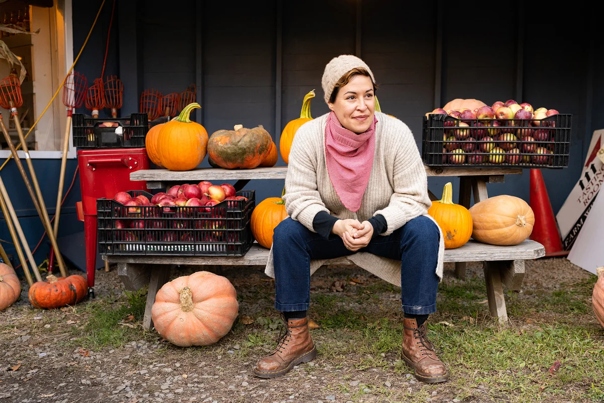 Autumn Portrait of Person Sitting with Pumpkins