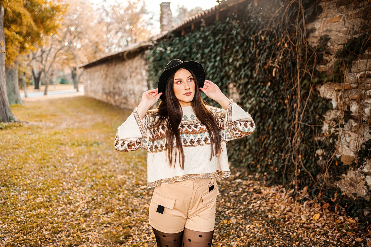 Beautiful young woman in the park on a warm autumn day