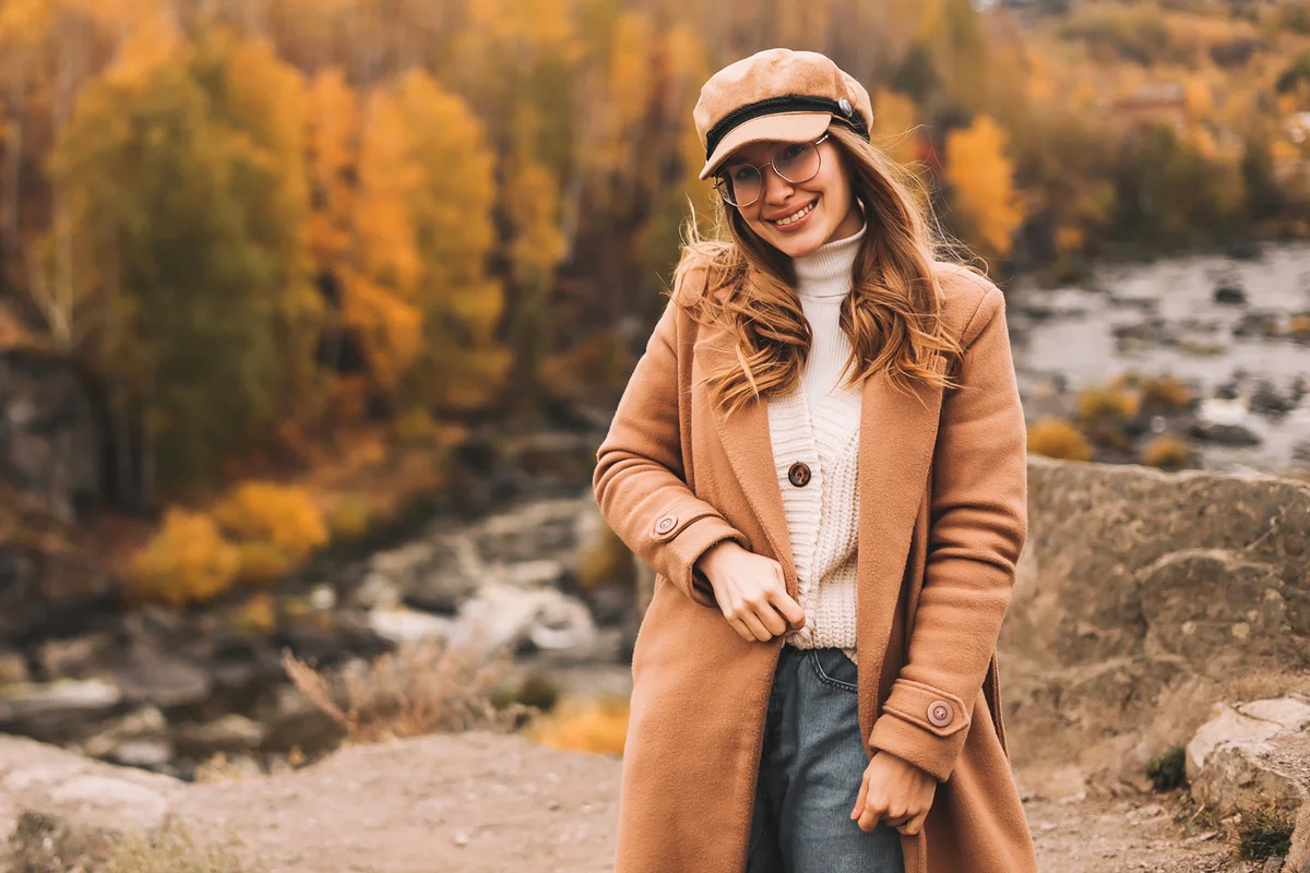 A happy young woman in a casual warm coat