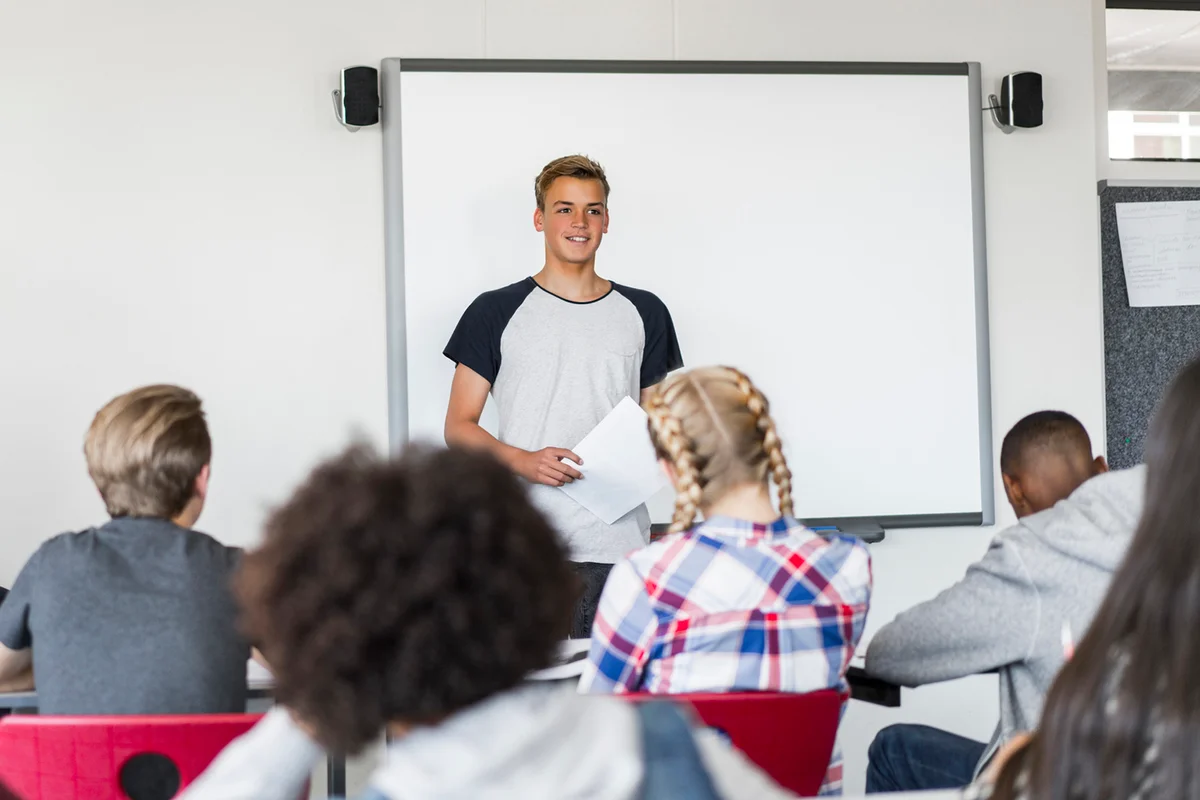 Student giving presentation in classroom at class