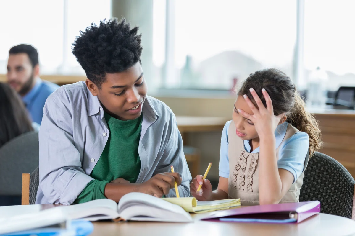 Teen giving lessons to young girl
