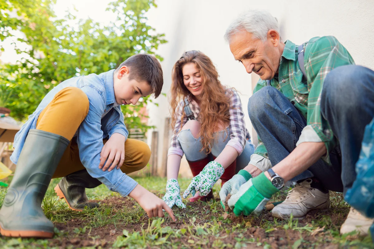 Teenager helping older neighbour with garden