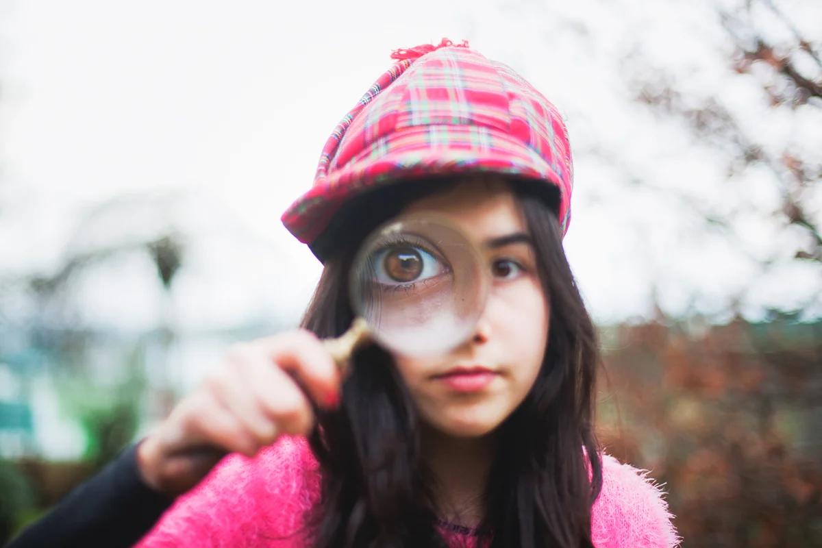 Little detective girl outdoors