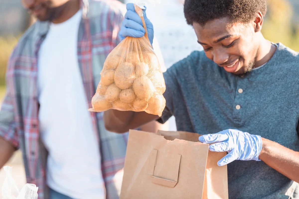 teen and parent volunteering at food bank