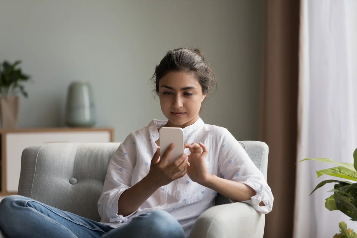 woman typing on phone