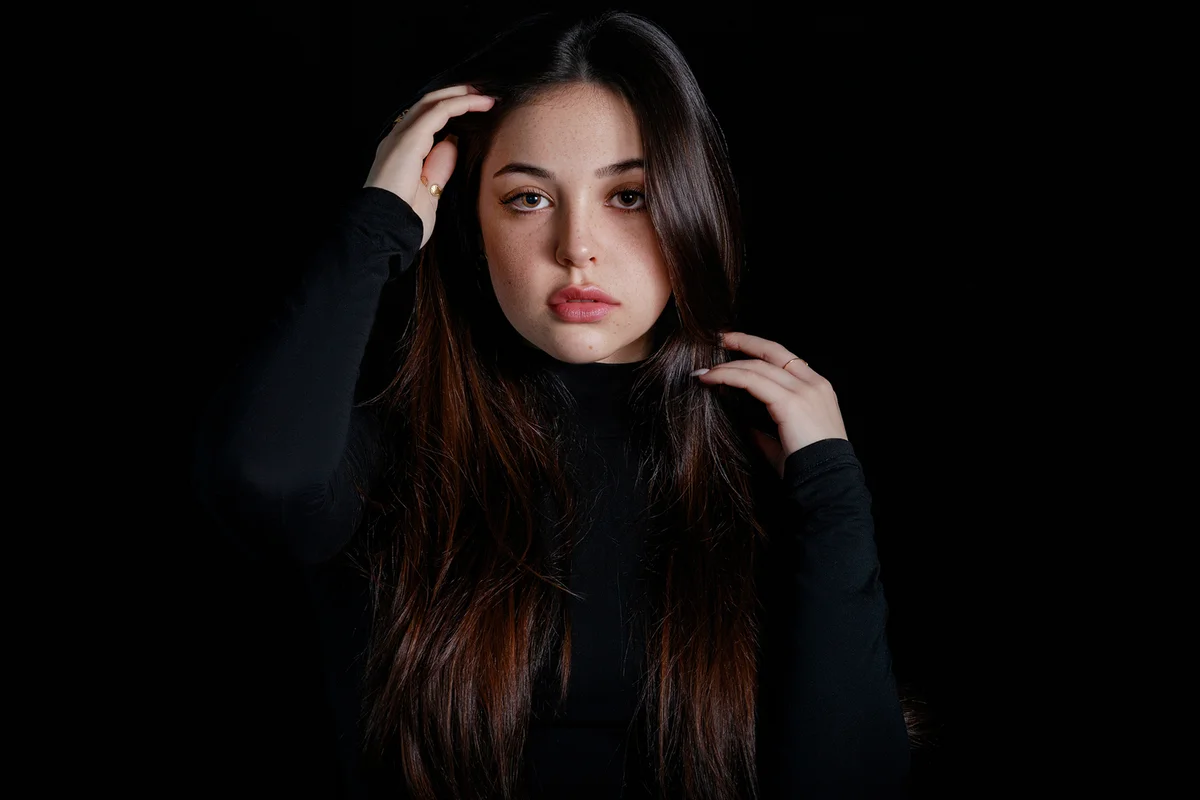 woman standing against black background