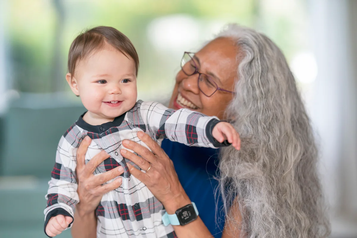 Happy baby girl playing with her grandma