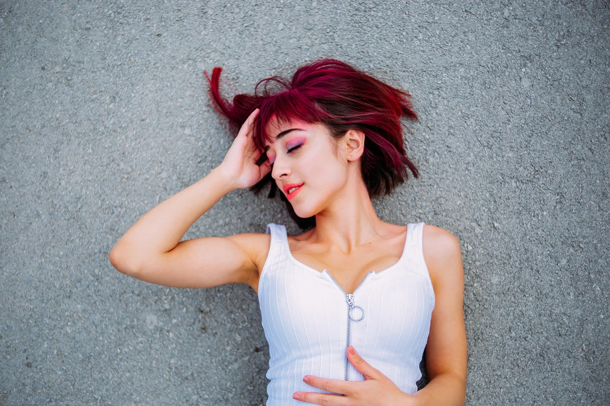 Redhead Woman Lying on Asphalt