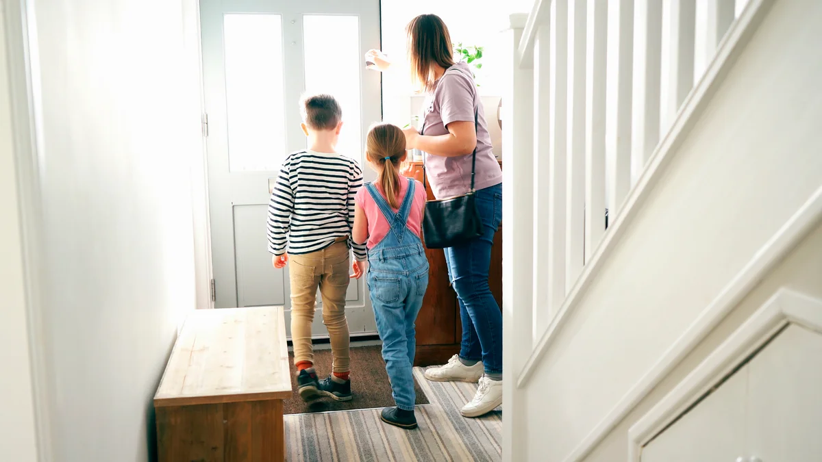 Family leaving house with kids