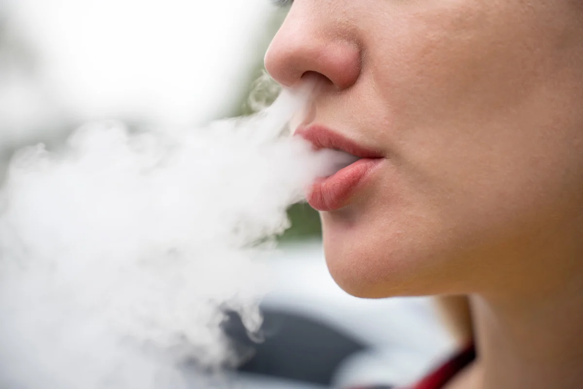 Closeup of of girls face while vaping