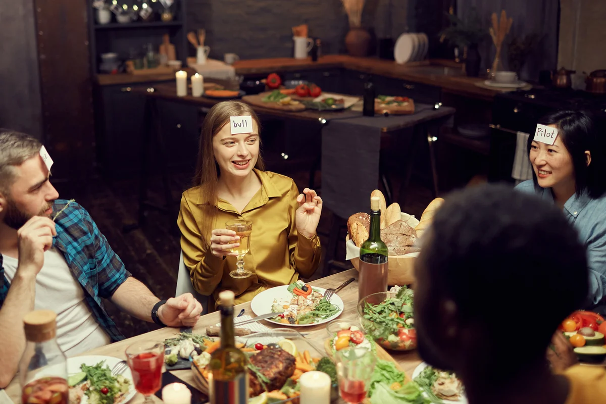 Friends Playing Guessing Game at Dinner