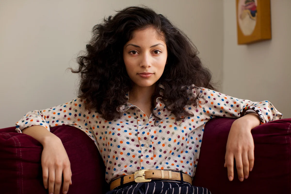 Portrait of woman sitting on couch looking at the camera
