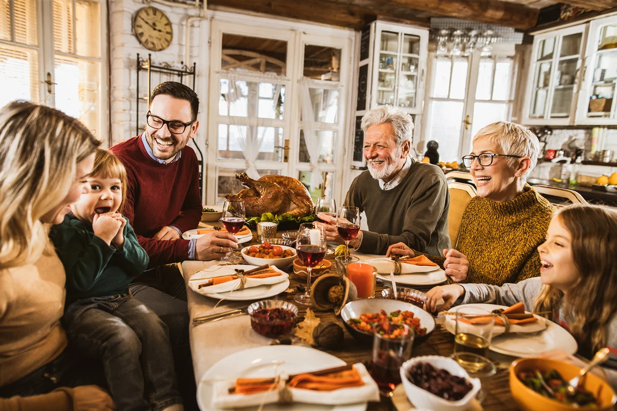 Happy extended family talking during Thanksgiving meal