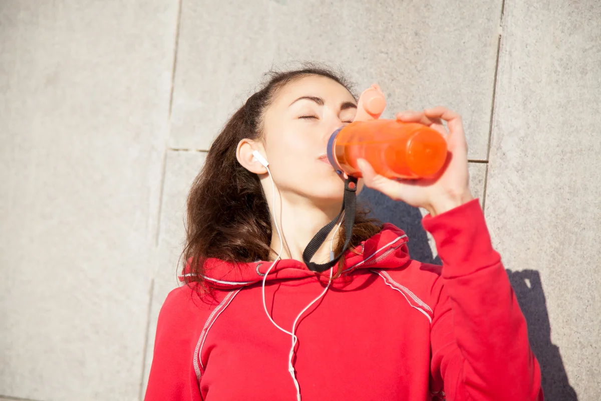 teenager drinking an energy drink