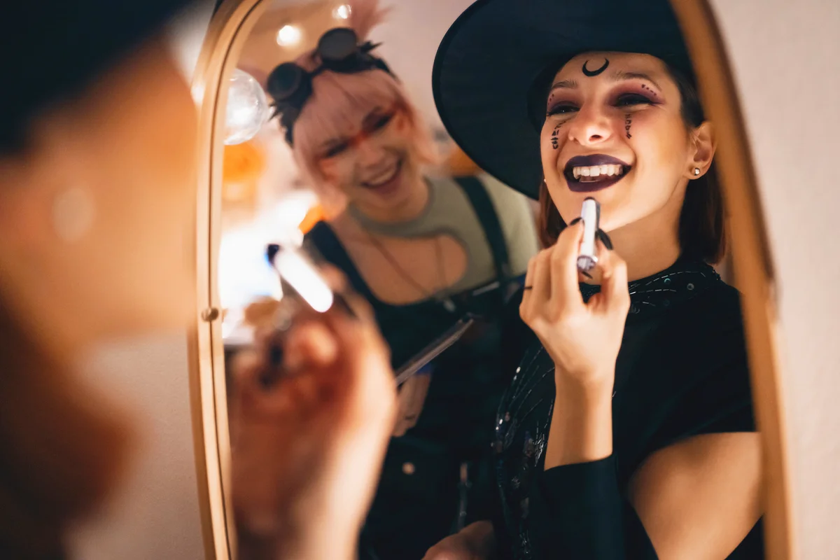 Friends doing make-up for Halloween party