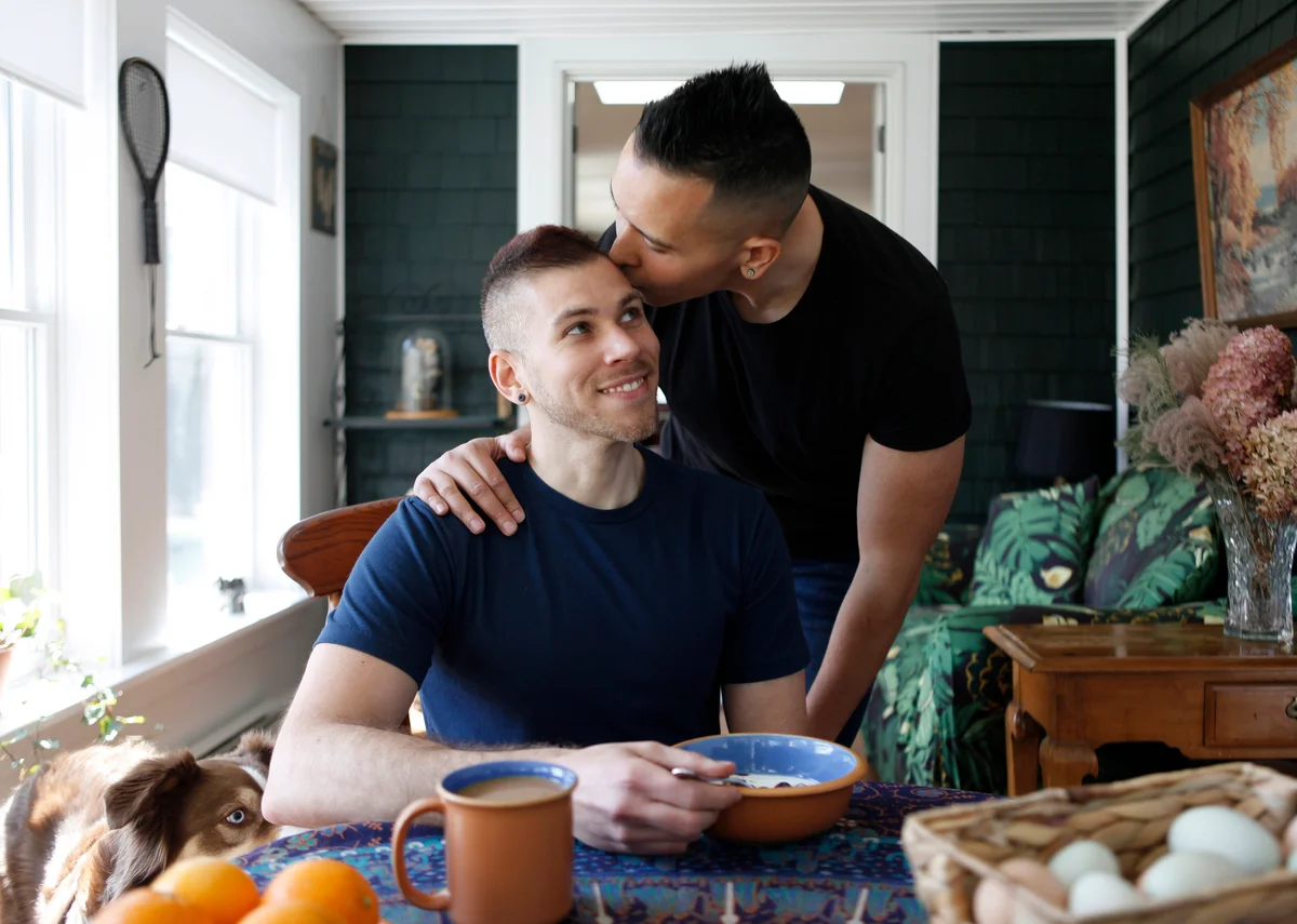 Man kissing his boyfriend on the forehead