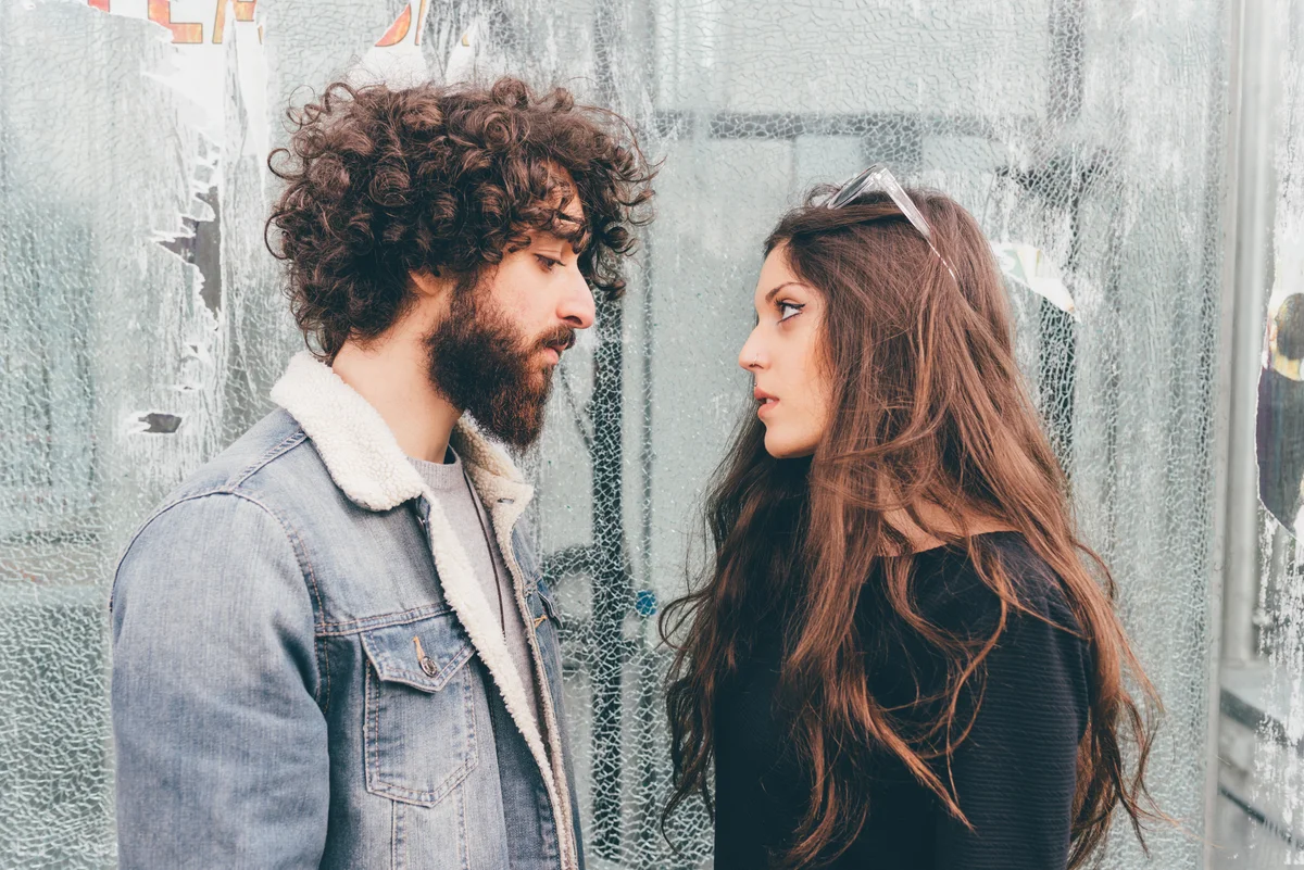 couple talking and looking at each other pensievely