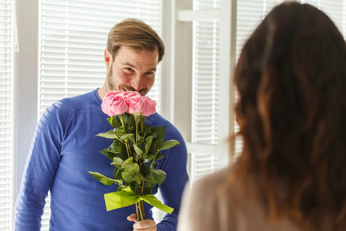 Man about to give his girlfriend flowers